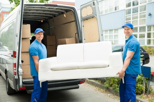 Man with van loading furniture in Hackney street