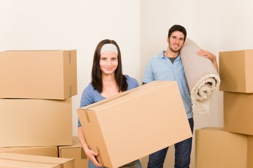Packed boxes and furniture being loaded into a removal van in Hackney